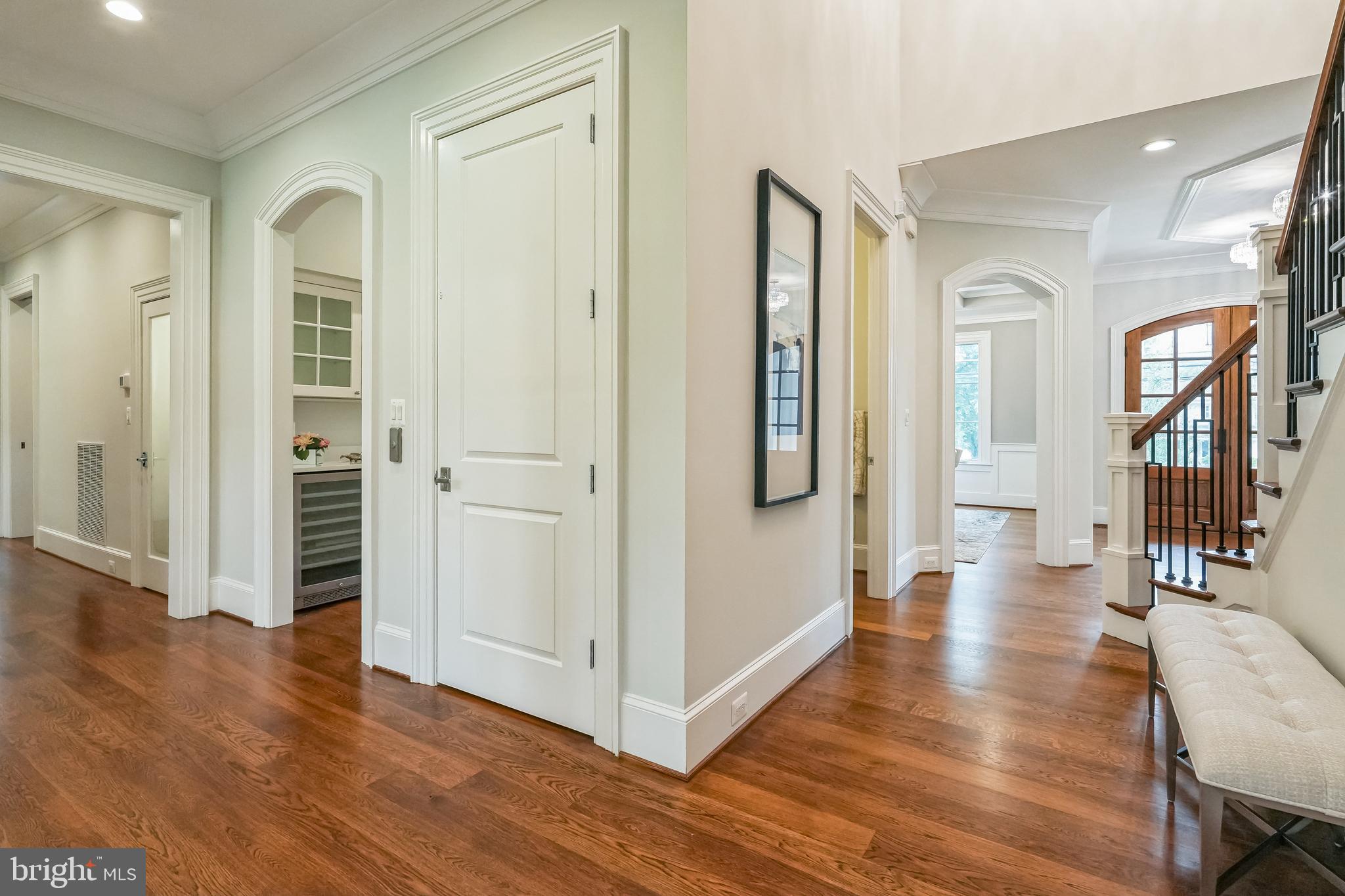 305 Old Courthouse Road Northeast Vienna, VA 22180 - Photo 10 of 69 a view of a hallway with wooden floor and livingroom with furniture