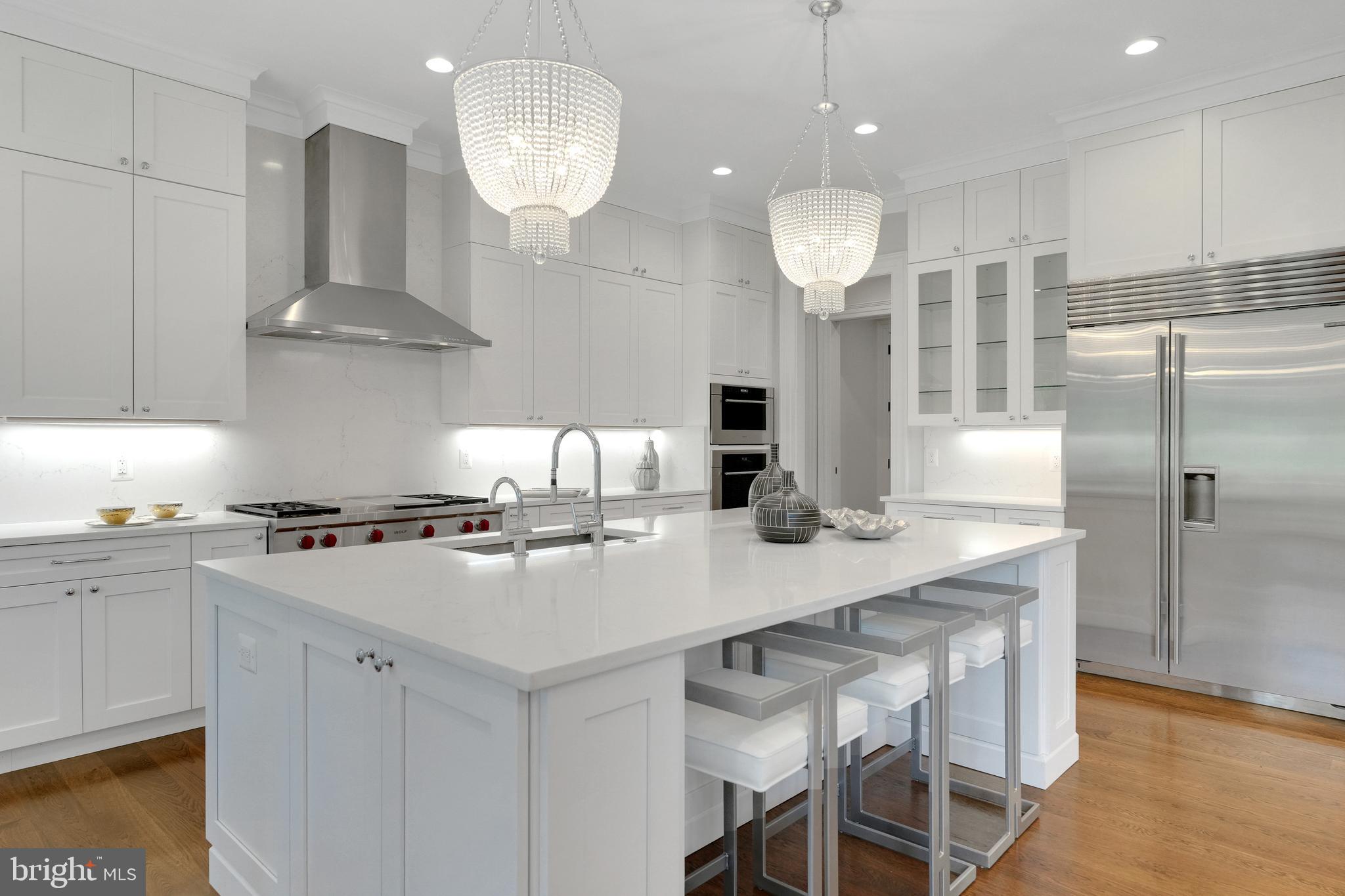 305 Old Courthouse Road Northeast Vienna, VA 22180 - Photo 16 of 69 a kitchen with stainless steel appliances a stove a sink island and a refrigerator