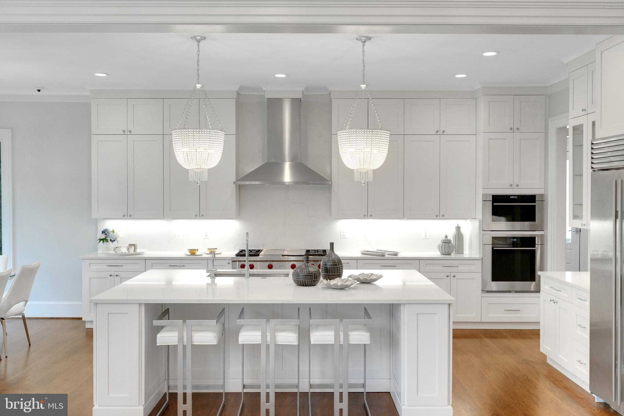 305 Old Courthouse Road Northeast Vienna, VA 22180 - Photo 18 of 69 a kitchen with a sink a stove and chairs
