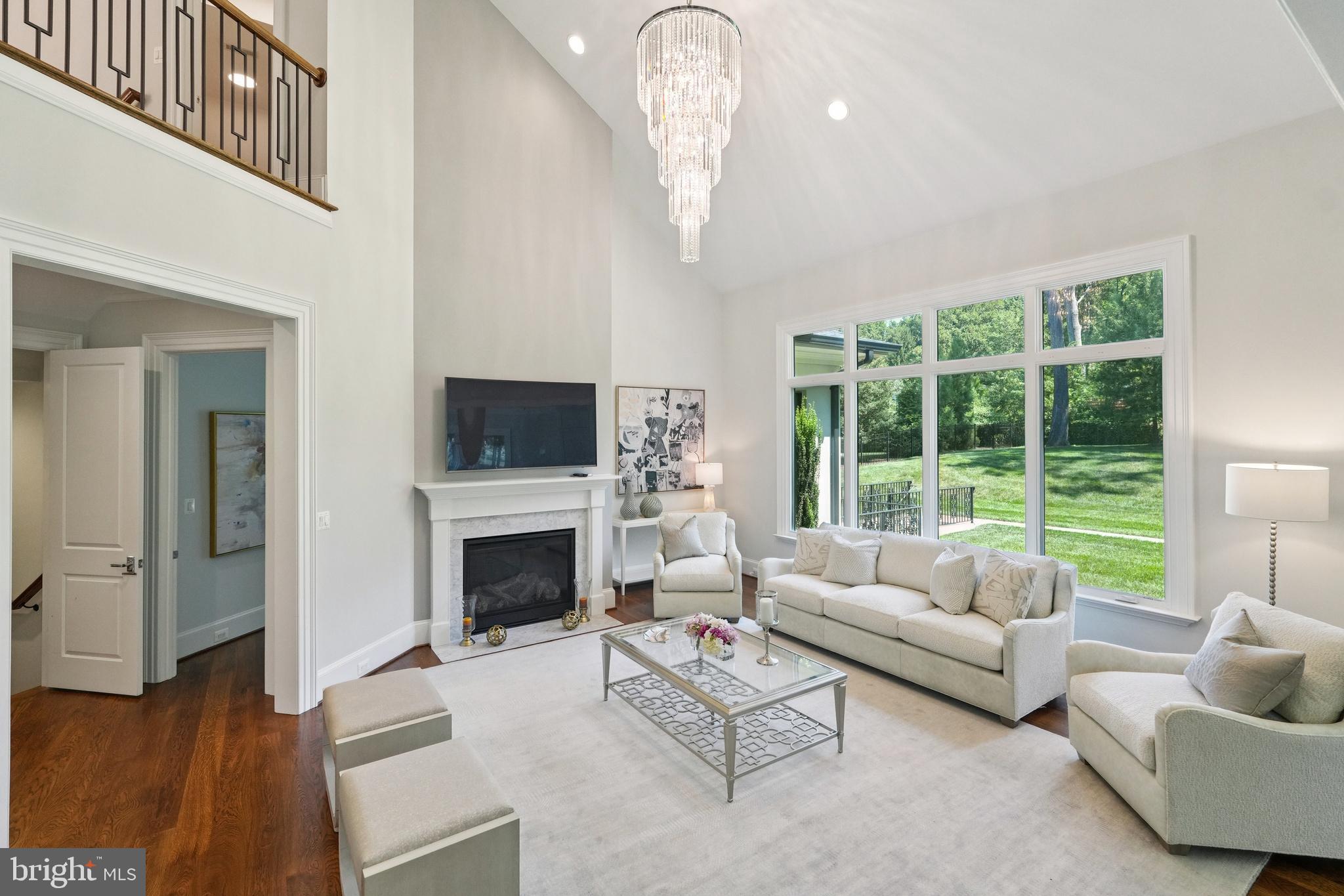 305 Old Courthouse Road Northeast Vienna, VA 22180 - Photo 22 of 69 a living room with furniture a fireplace and a flat screen tv
