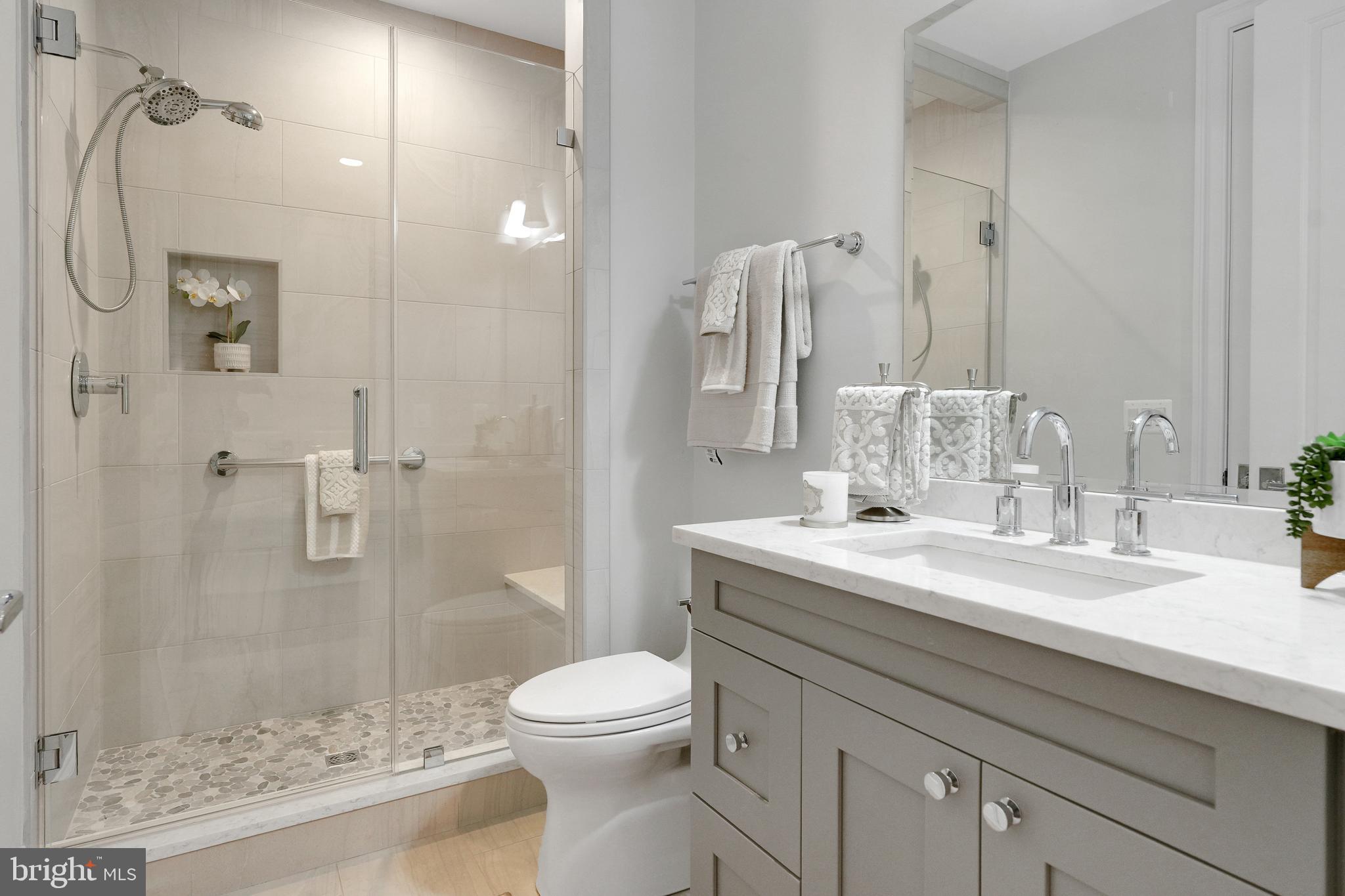 305 Old Courthouse Road Northeast Vienna, VA 22180 - Photo 33 of 69 a bathroom with a granite countertop sink a toilet and shower