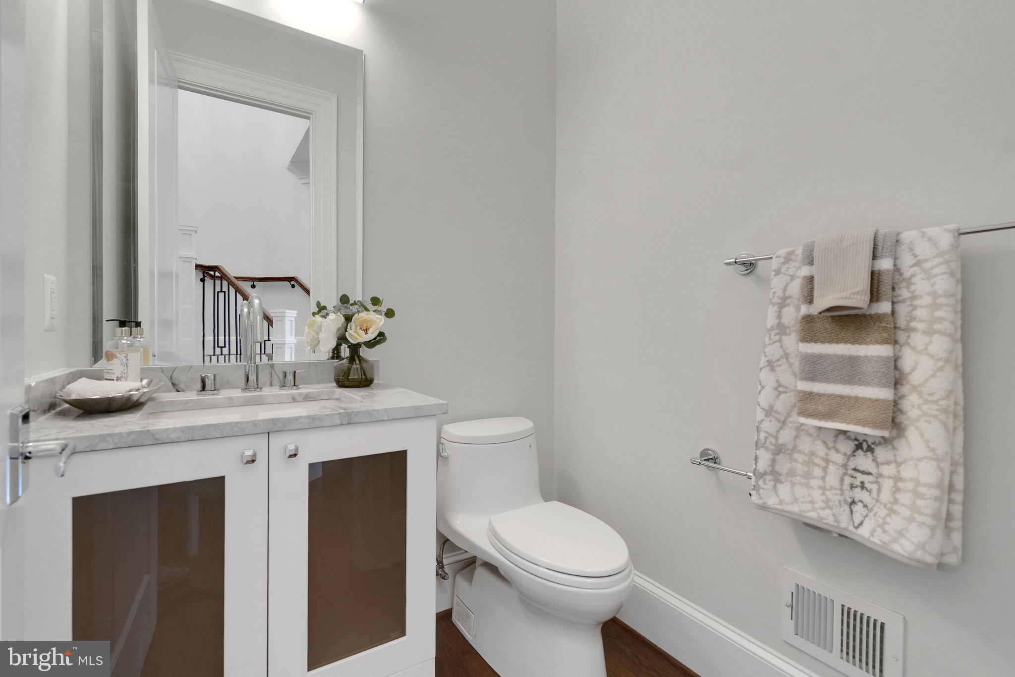 305 Old Courthouse Road Northeast Vienna, VA 22180 - Photo 35 of 69 a bathroom with a toilet sink and mirror