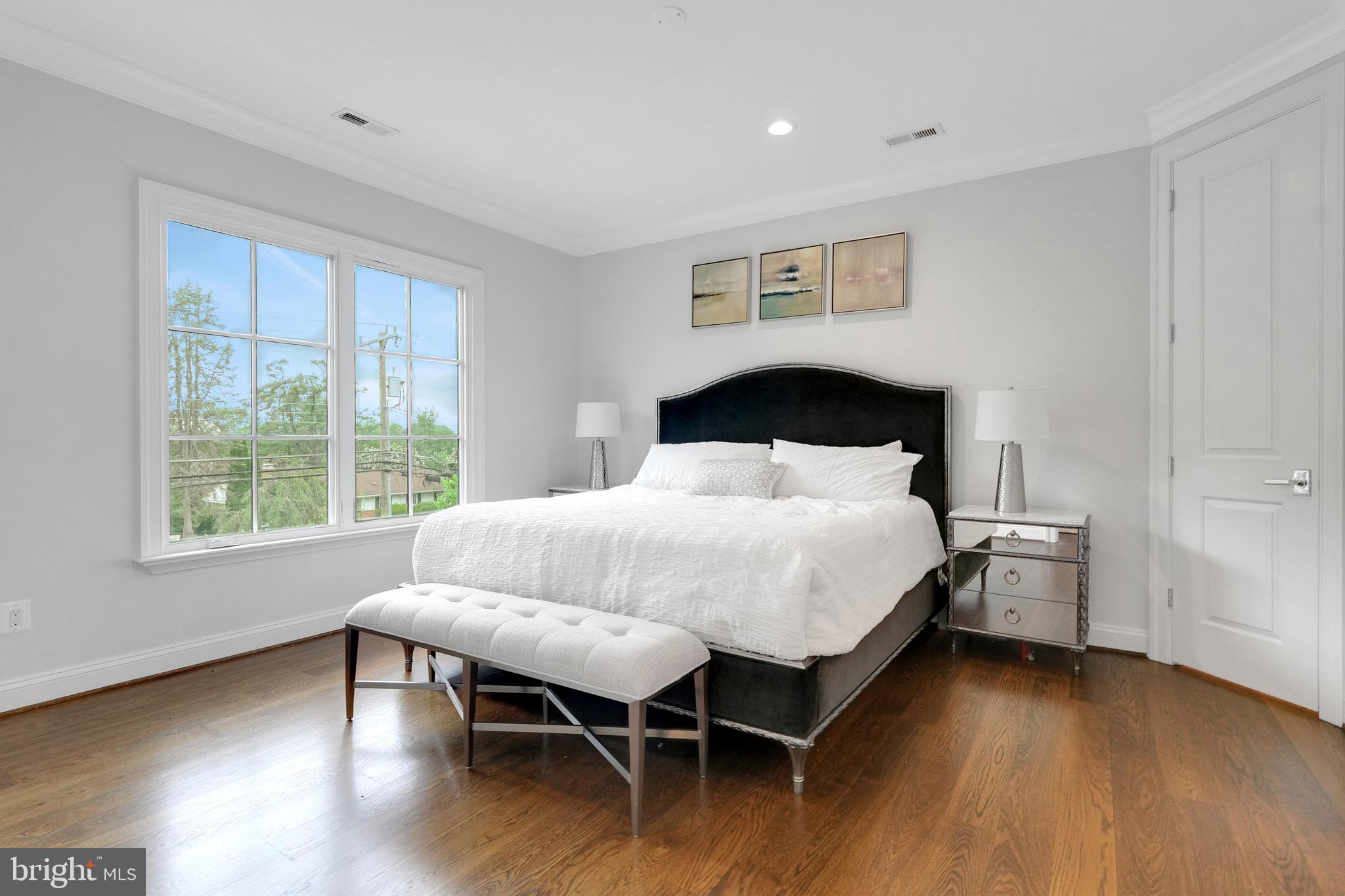305 Old Courthouse Road Northeast Vienna, VA 22180 - Photo 39 of 69 a bedroom with a bed and wooden floor