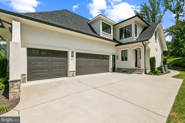 a view of staircase with railing and white walls