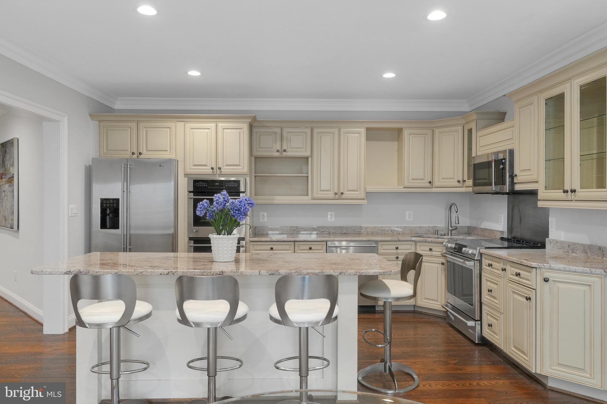 305 Old Courthouse Road Northeast Vienna, VA 22180 - Photo 50 of 69 a kitchen with kitchen island granite countertop a sink and cabinets