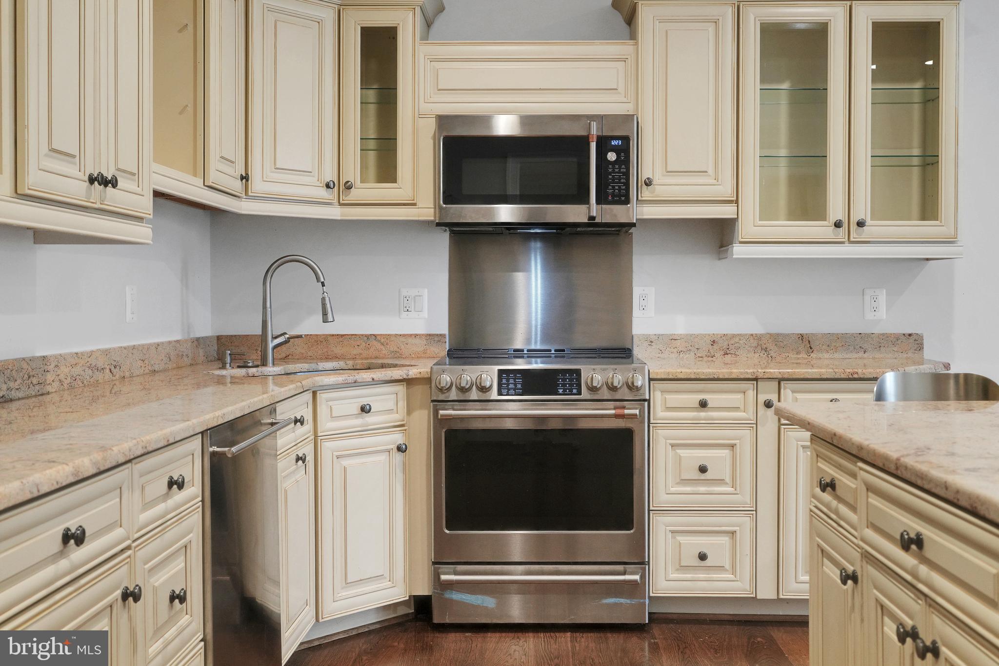 305 Old Courthouse Road Northeast Vienna, VA 22180 - Photo 52 of 69 a kitchen with stainless steel appliances granite countertop a stove and a microwave