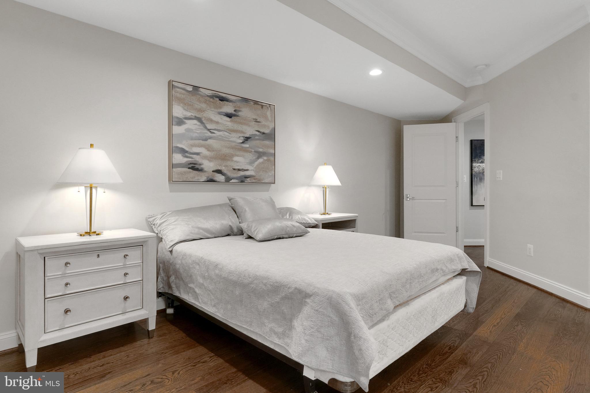305 Old Courthouse Road Northeast Vienna, VA 22180 - Photo 54 of 69 a bedroom with a bed and a lamp on dresser