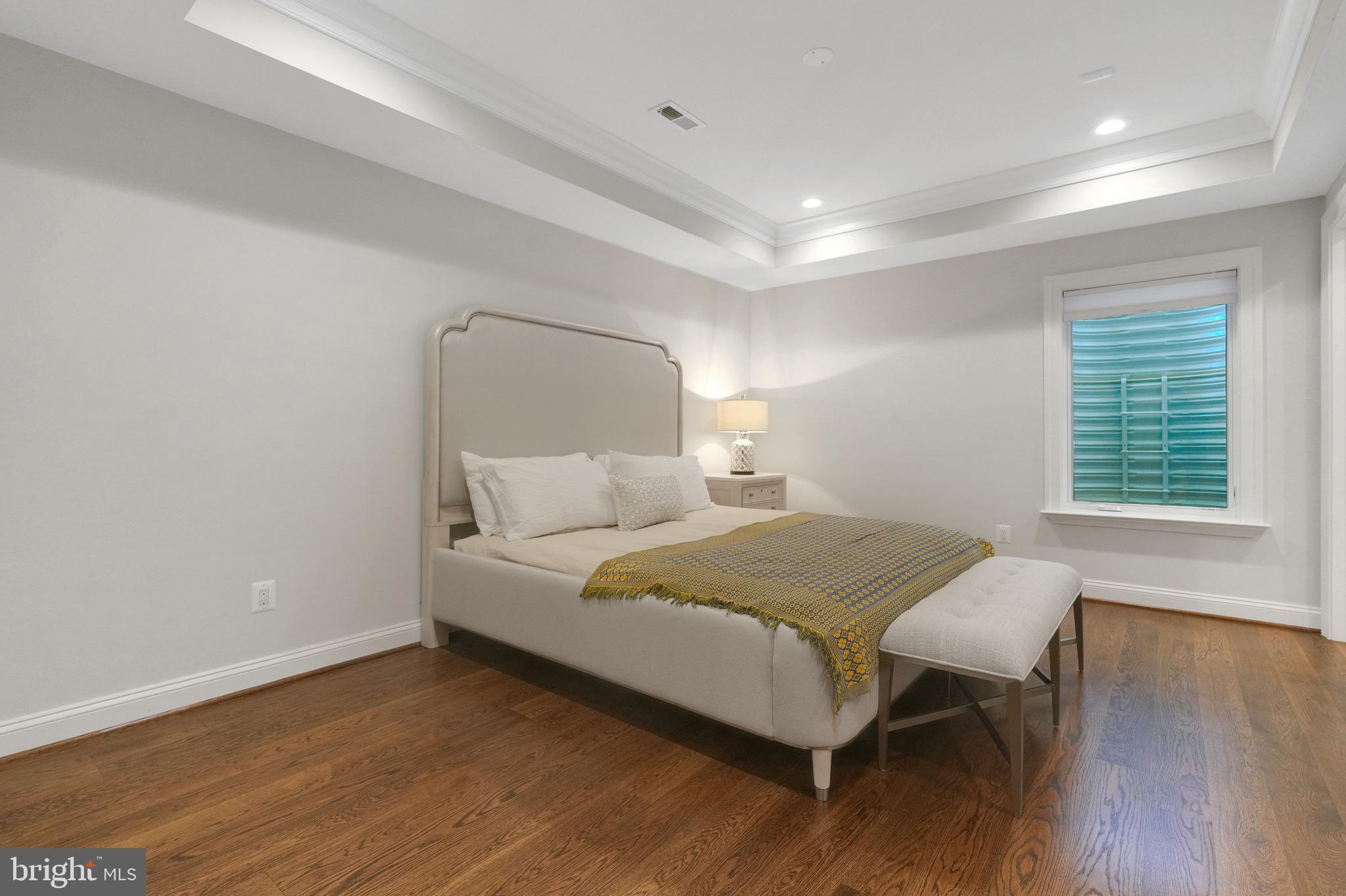 305 Old Courthouse Road Northeast Vienna, VA 22180 - Photo 57 of 69 a bedroom with a bed and wooden floor