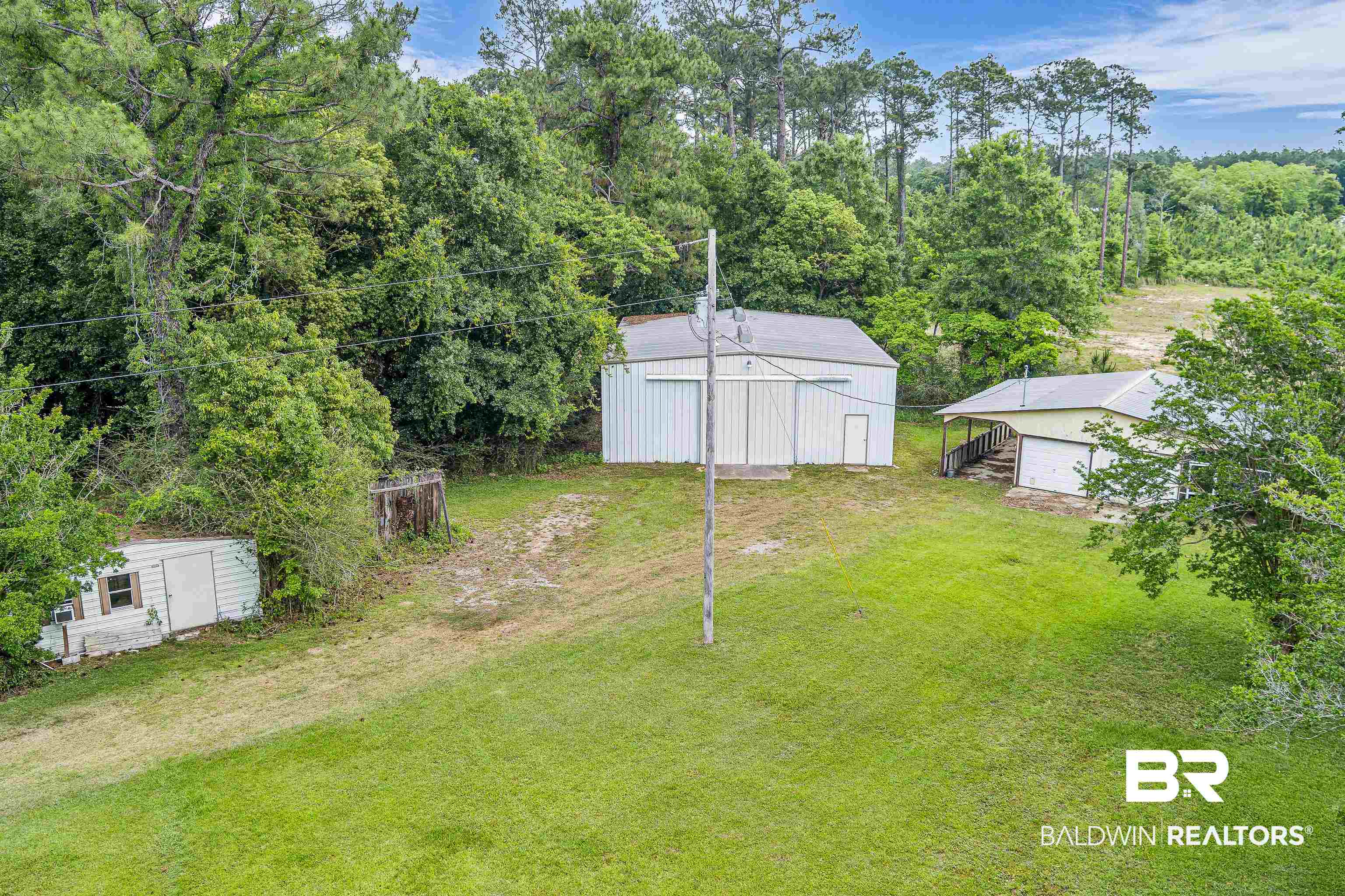 9530 Pilgrim Drive Elberta, AL 36530 - Photo 52 of 61 View of yard featuring a pole building, a forest view, an outbuilding, and a detached garage