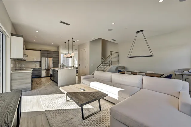 a living room with furniture and kitchen view