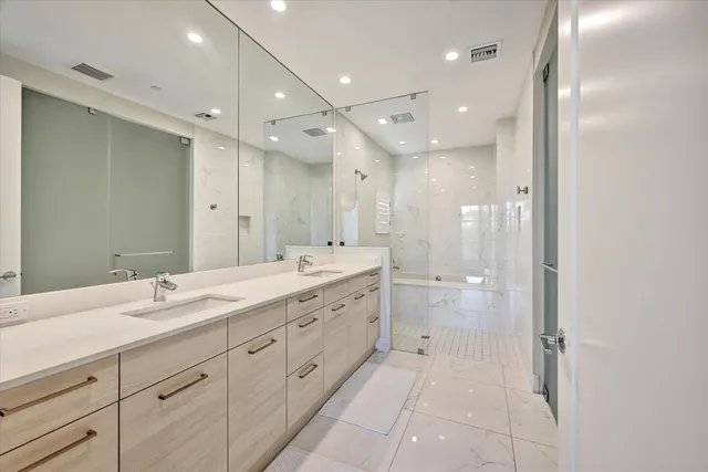 a spacious bathroom with a double vanity sink mirror and double