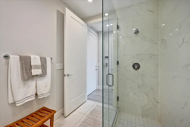 a bathroom with a shower and a glass door