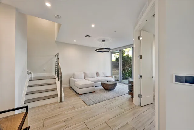 a living room with furniture and a potted plant