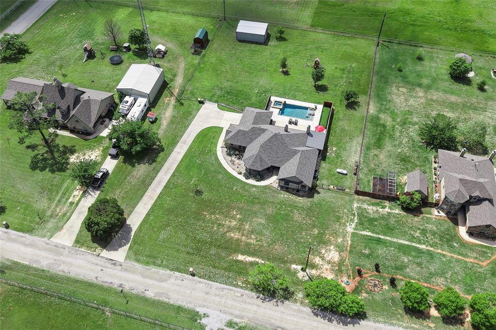 199 Newfield Lane Springtown, TX 76082 - Photo 37 of 38 This expansive property features extensive green lawn space, pool, putting green, playground, shop and a paved driveway