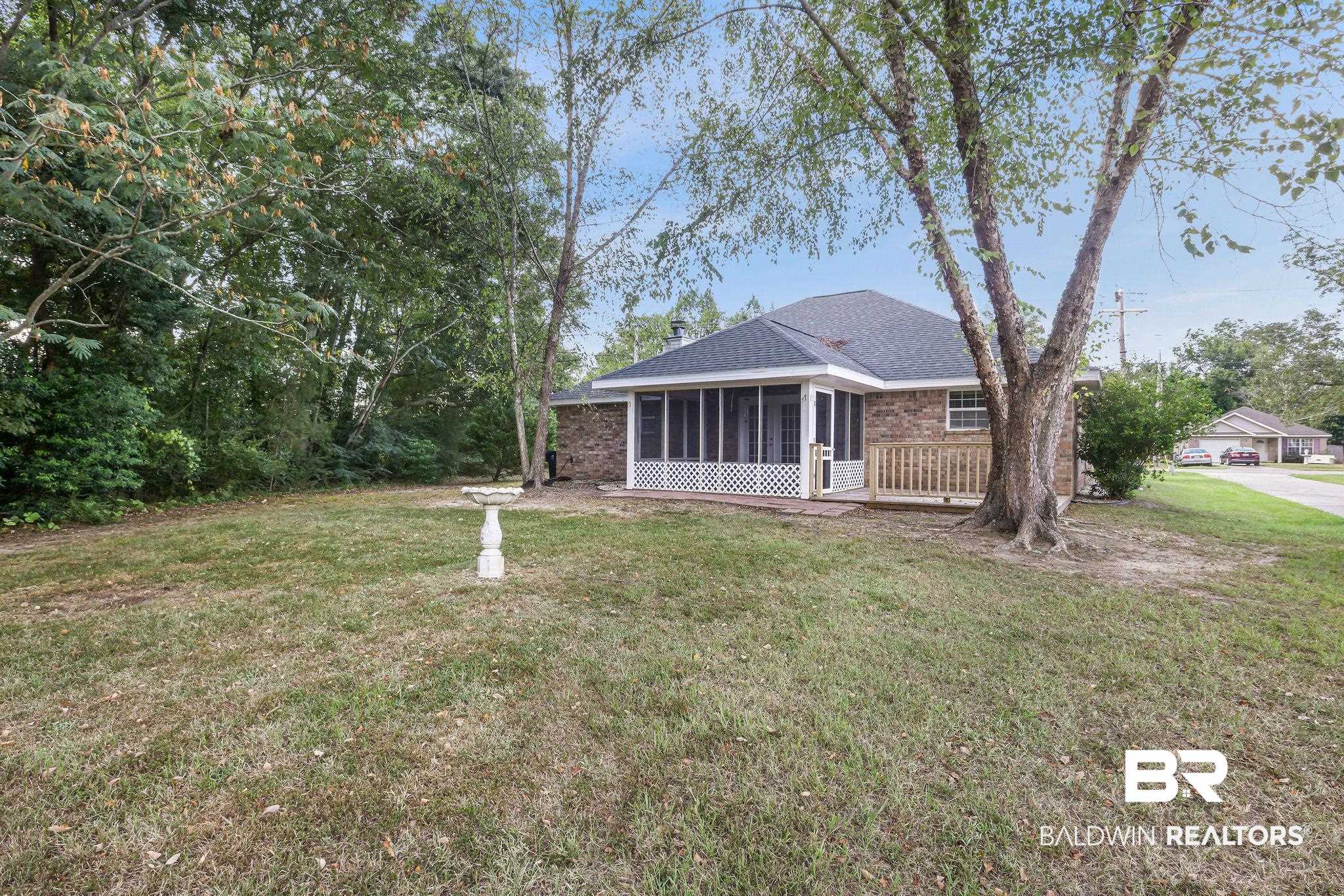 18620 Hammond Street Robertsdale, AL 36567 - Photo 21 of 23 View of front of home with a front lawn and a sunroom