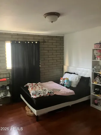 a bedroom with a bed and a night stand