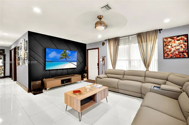 a living room with stainless steel appliances kitchen island granite countertop furniture and a kitchen view