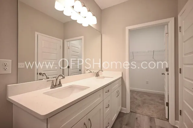 a bathroom with a sink vanity granite and a mirror
