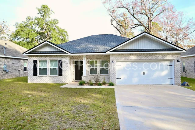 a front view of a house with a yard and porch