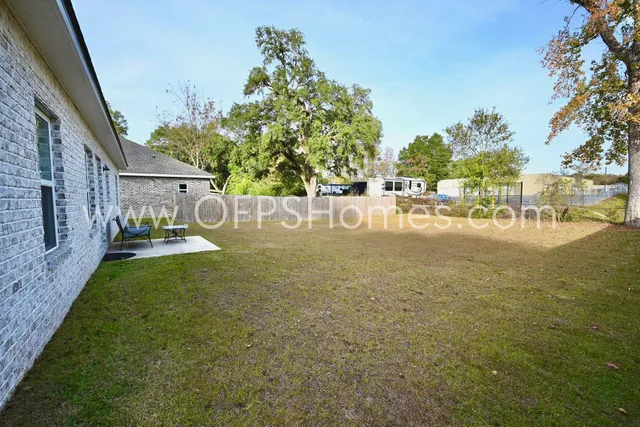 a view of backyard with outdoor space and trees