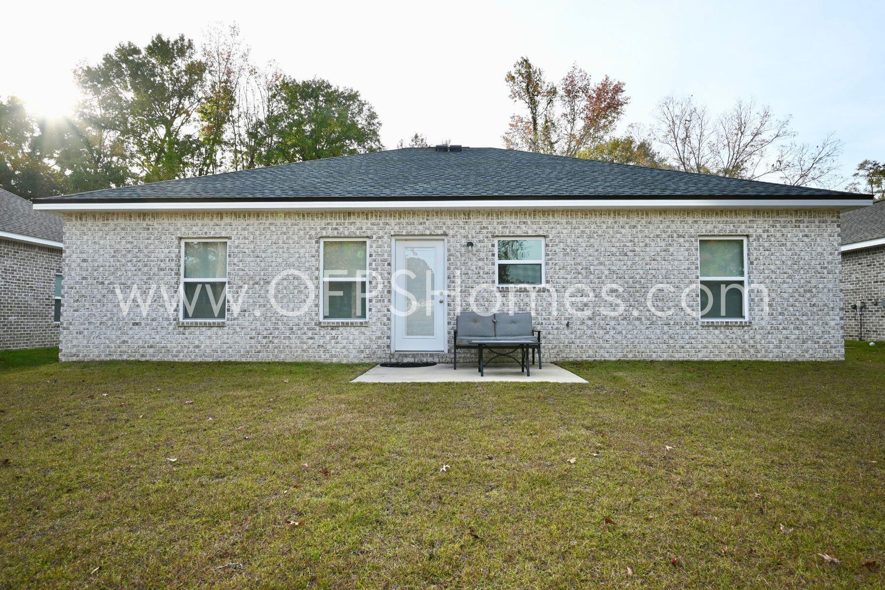 113 Shady Lane Crestview, FL 32536 - Photo 25 of 25 a view of a house with pool and a garden
