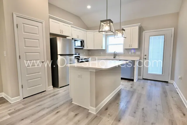a kitchen with cabinets and stainless steel appliances