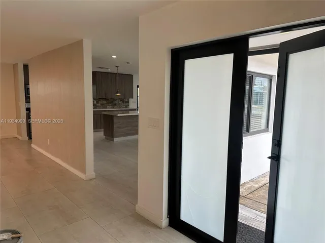 a large kitchen with kitchen island granite countertop a sink window and cabinets