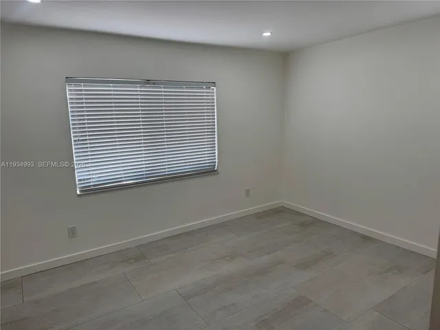 a kitchen with stainless steel appliances a refrigerator a sink a stove a microwave and a refrigerator