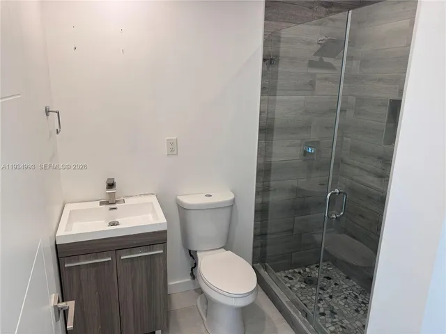 an empty room with wooden floor and natural light