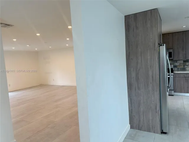 a view of an empty room and a window