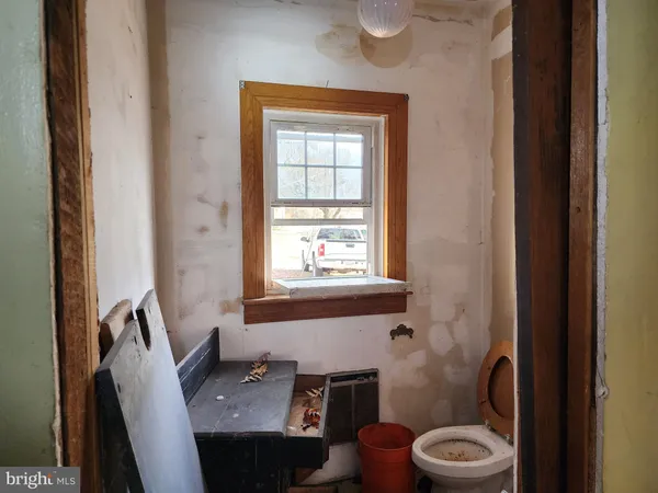 a bathroom with a toilet a sink and a window