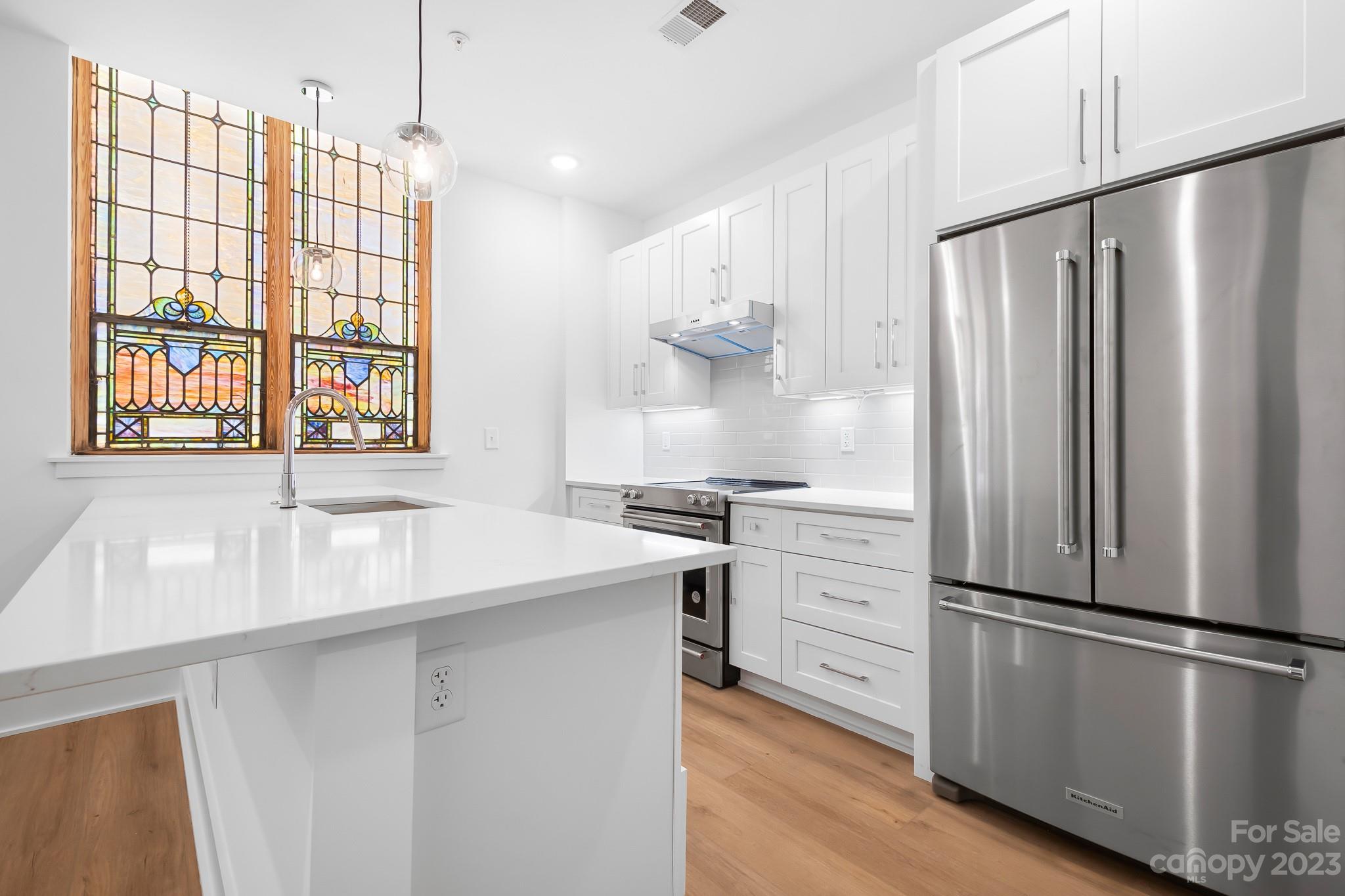 201 Grandin Road, Unit 12 Charlotte, NC 28208 - Photo 1 of 13 a kitchen with stainless steel appliances a refrigerator sink and cabinets