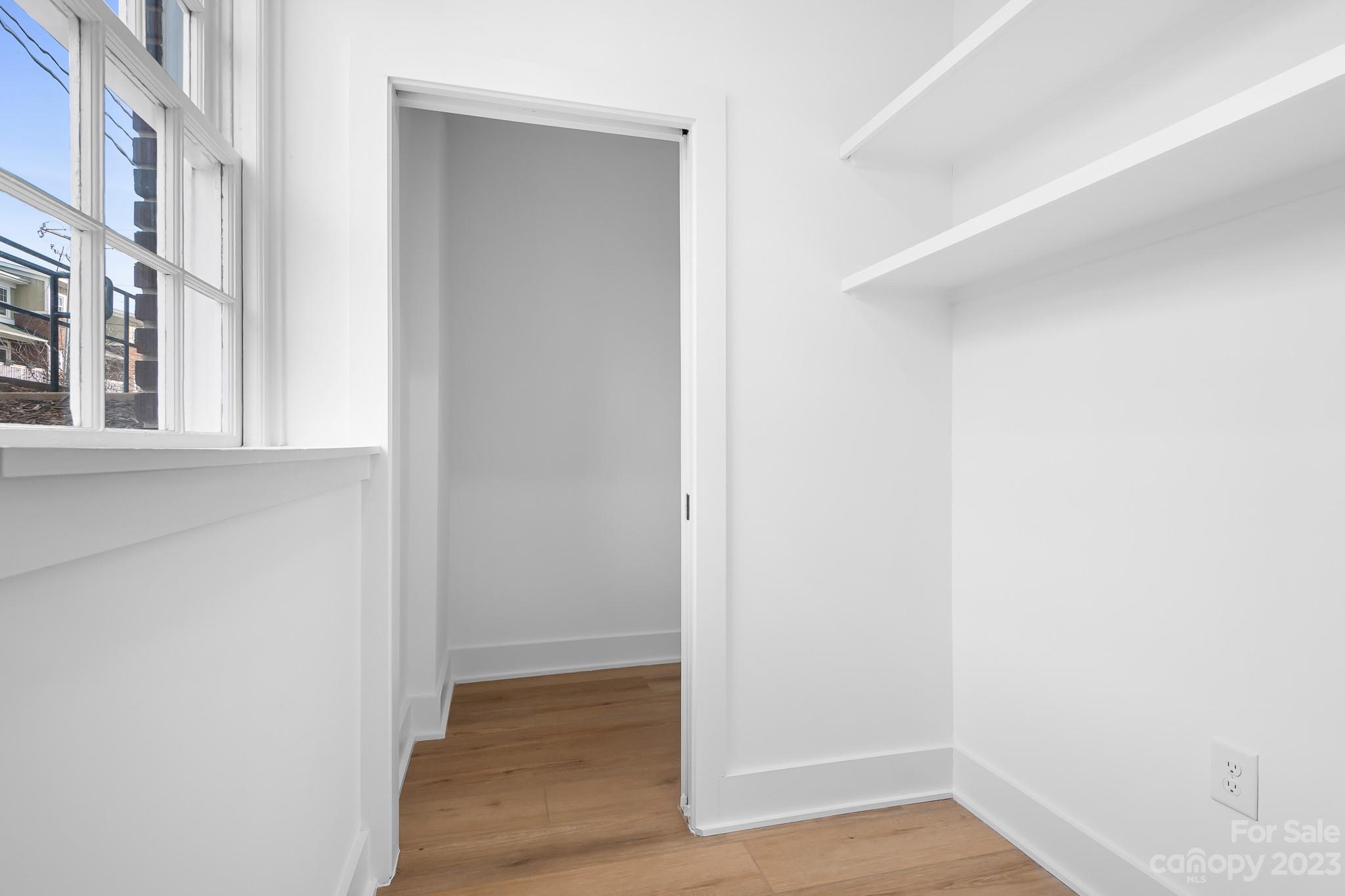 201 Grandin Road, Unit 12 Charlotte, NC 28208 - Photo 13 of 13 a view of an empty room with wooden floor and a window
