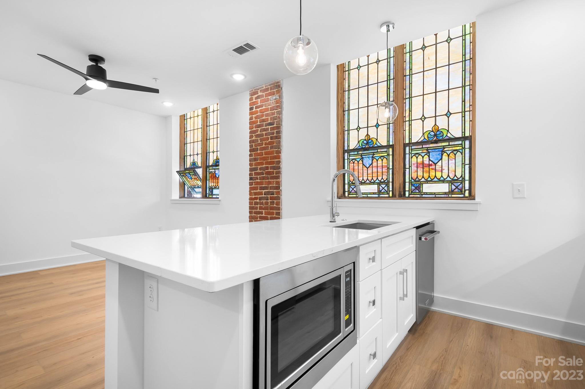 201 Grandin Road, Unit 12 Charlotte, NC 28208 - Photo 2 of 13 a kitchen that has a sink and a stove in it