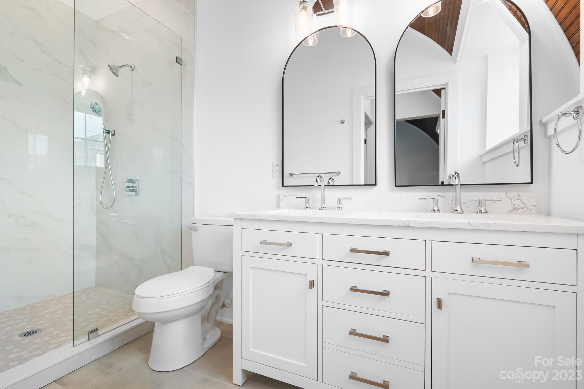 201 Grandin Road, Unit 12 Charlotte, NC 28208 - Photo 6 of 13 a bathroom with a double vanity sink mirror and toilet
