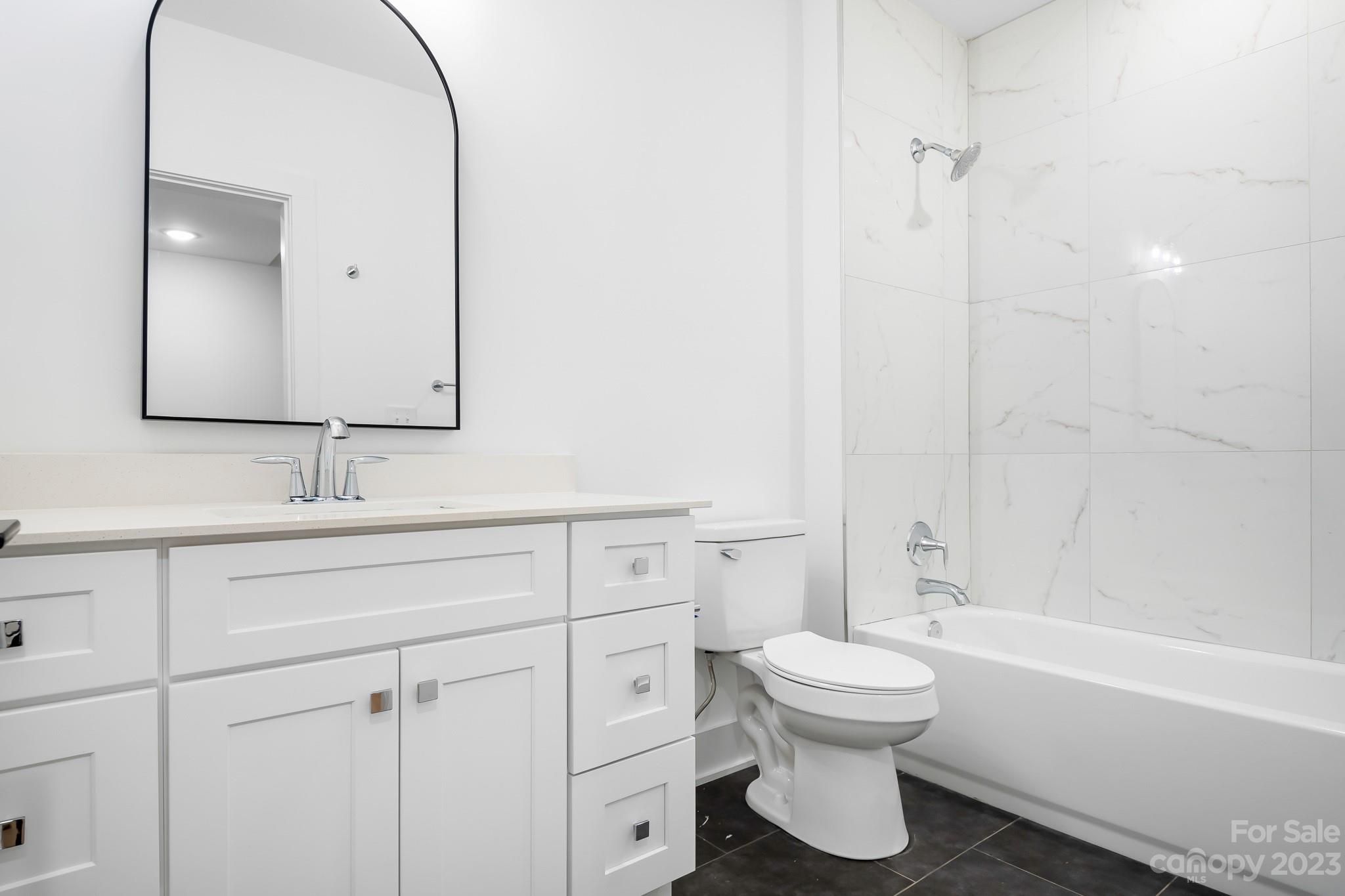 201 Grandin Road, Unit 12 Charlotte, NC 28208 - Photo 8 of 13 a bathroom with a toilet sink and mirror