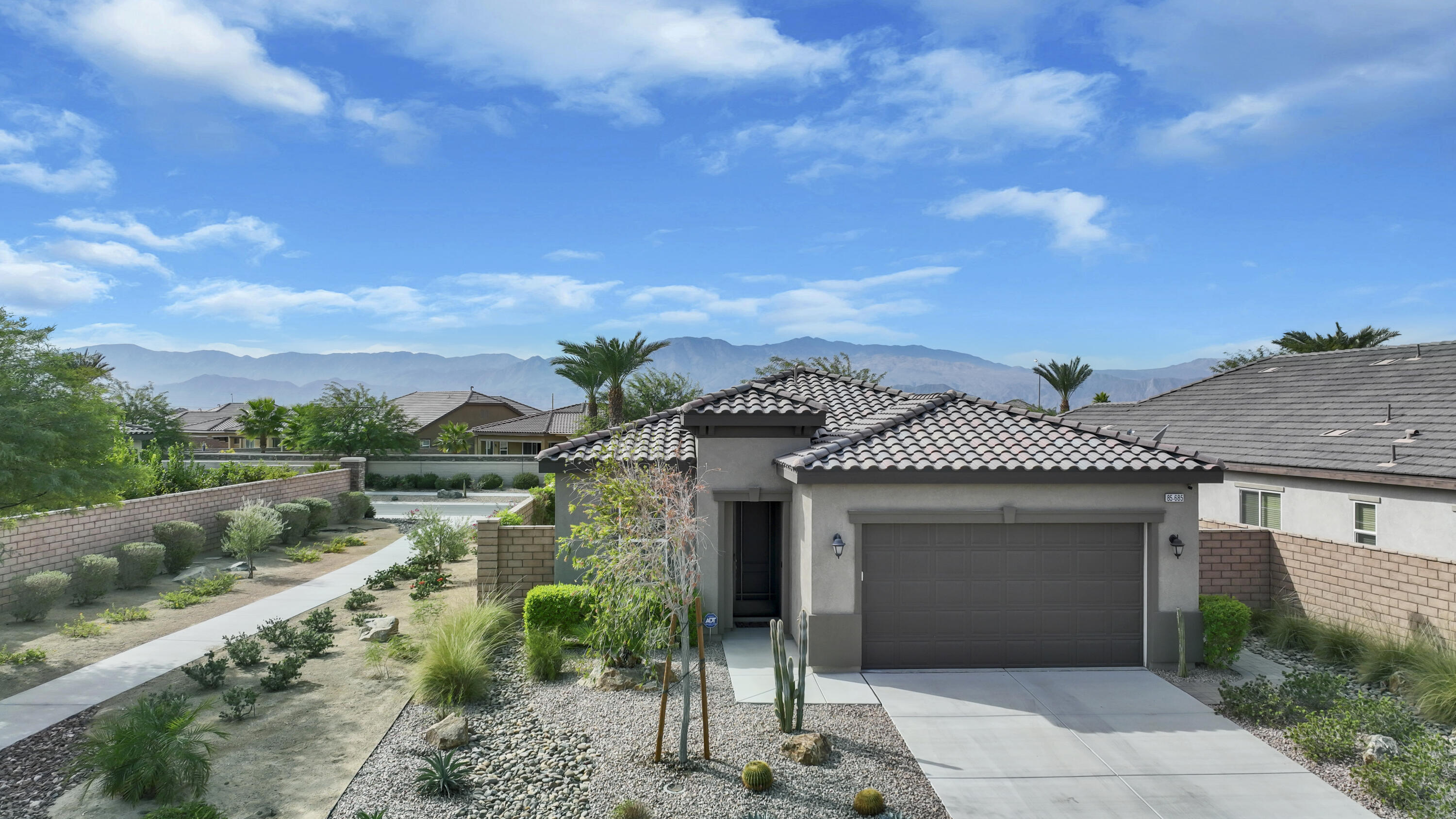 85685 Treviso Drive Indio, CA 92203 - Photo 1 of 32 a front view of a house with a yard