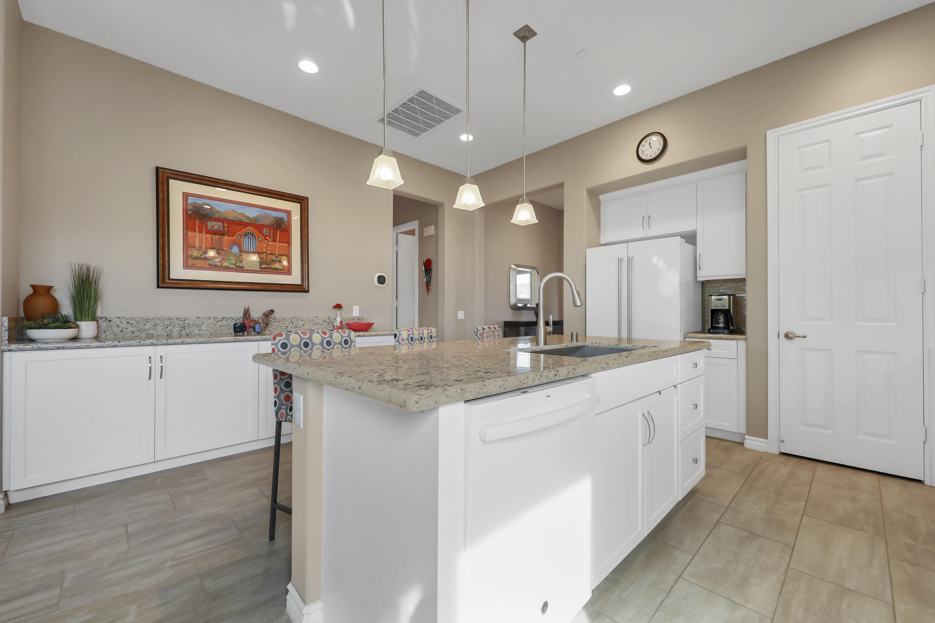 85685 Treviso Drive Indio, CA 92203 - Photo 14 of 32 a spacious bathroom with a granite countertop sink a mirror and a bathtub