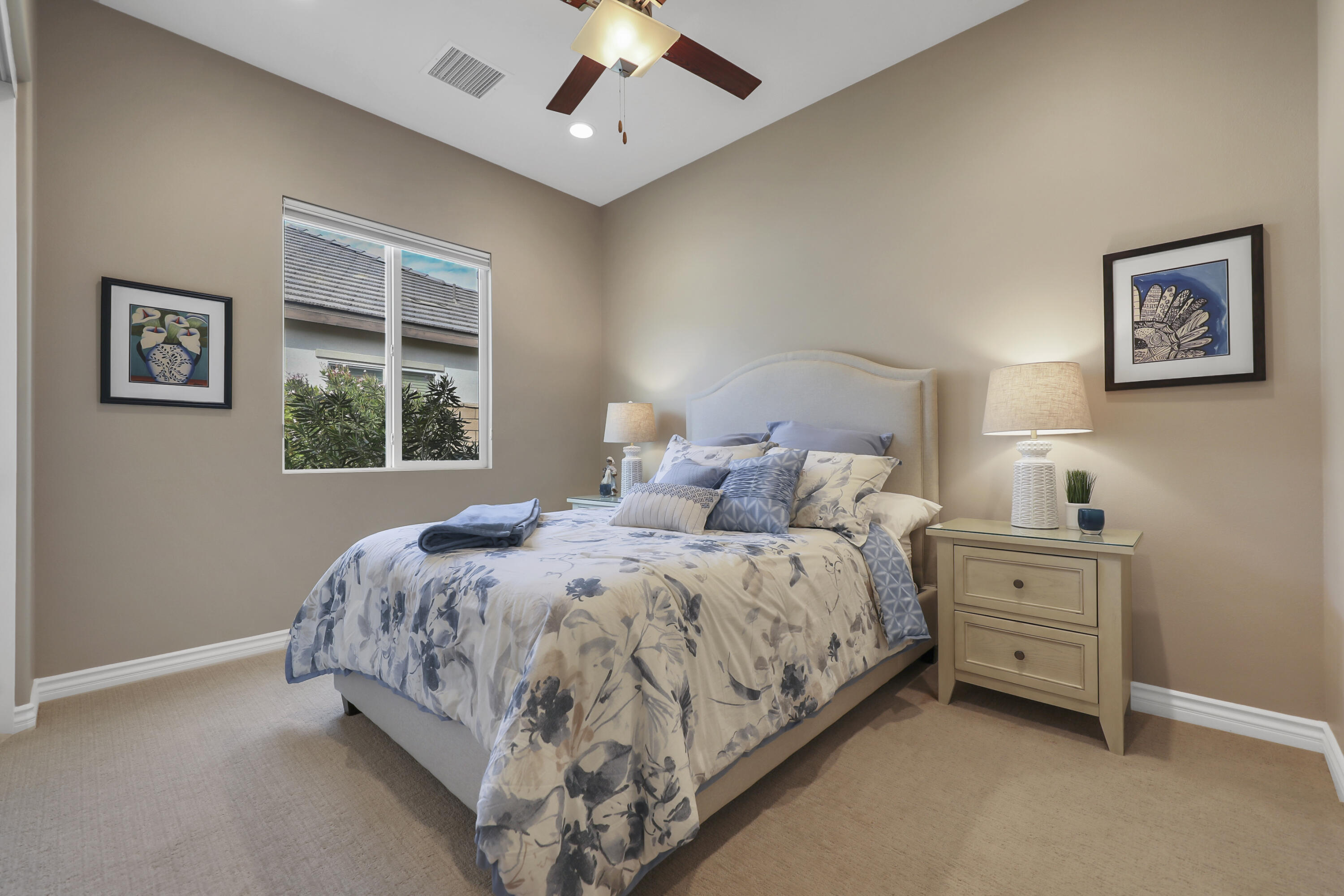 85685 Treviso Drive Indio, CA 92203 - Photo 19 of 32 a spacious bedroom with a bed and a window