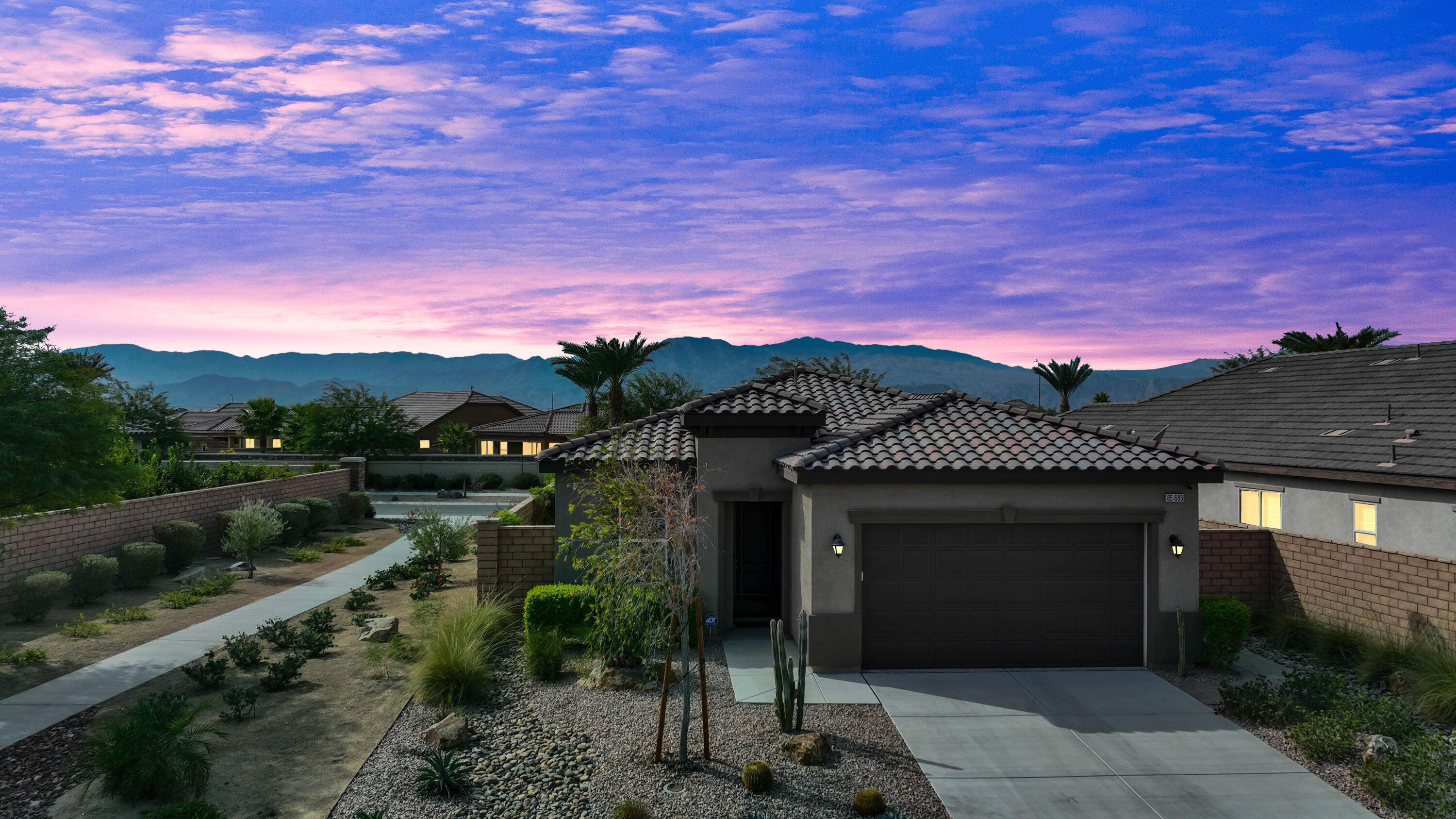 85685 Treviso Drive Indio, CA 92203 - Photo 2 of 32 a front view of a house with a yard