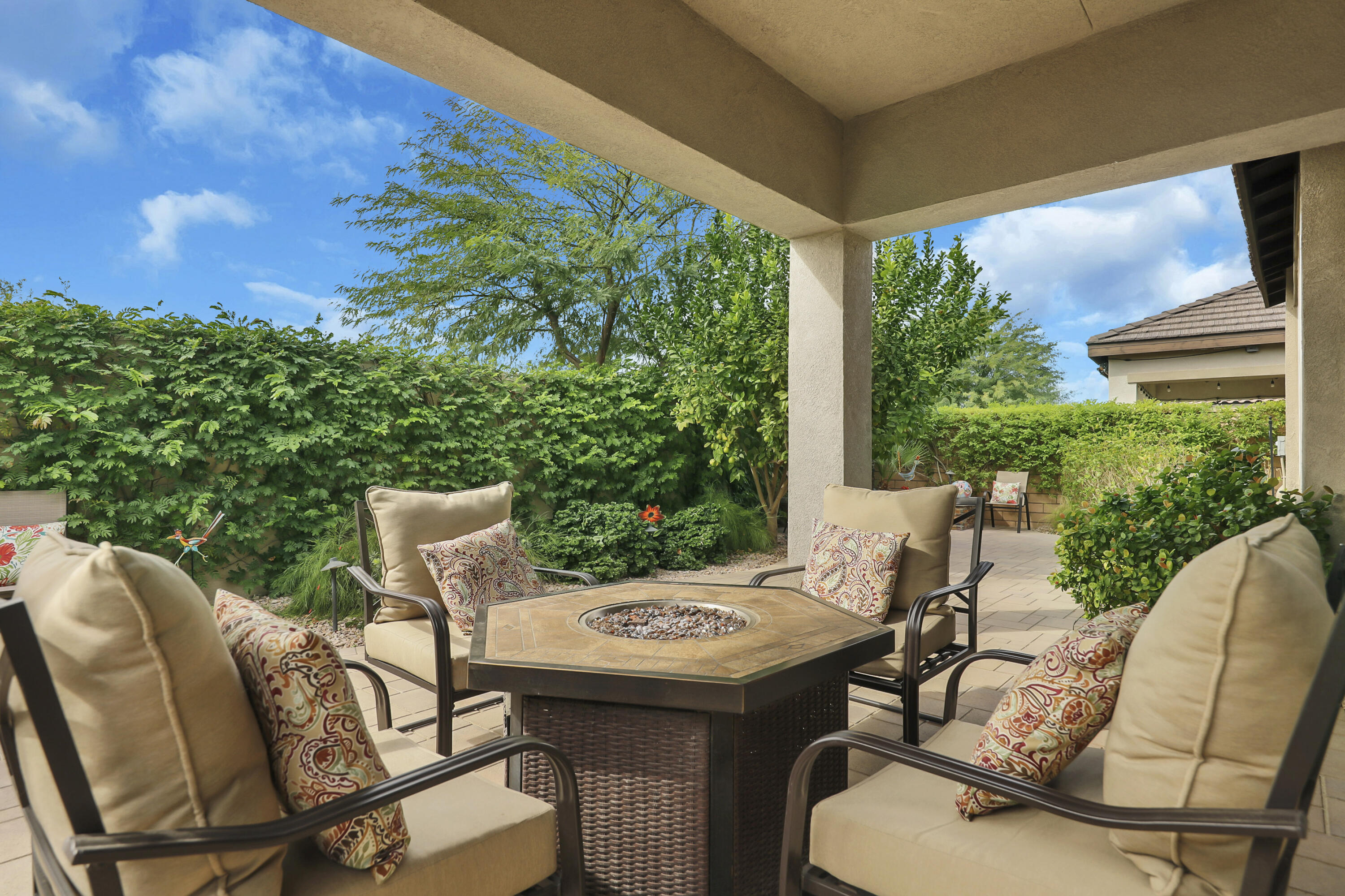 85685 Treviso Drive Indio, CA 92203 - Photo 22 of 32 a view of a patio with table and chairs with wooden floor and fence