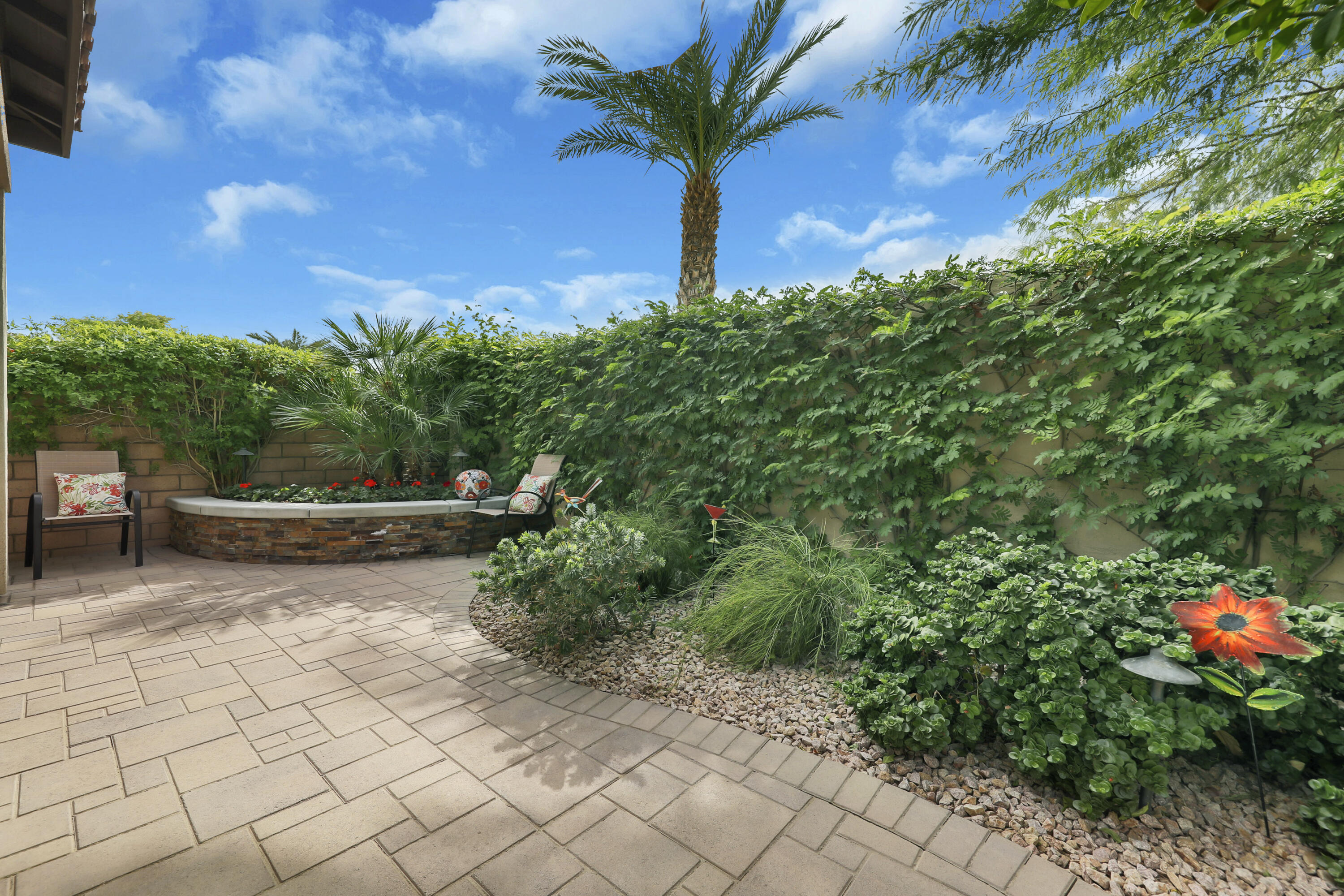 85685 Treviso Drive Indio, CA 92203 - Photo 29 of 32 a view of a yard with plants and a bench