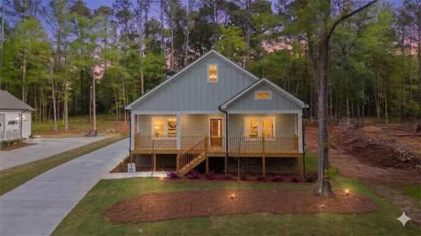 a view of a house with backyard and sitting area