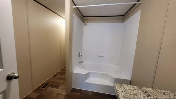 a bathroom with a bathtub and shower