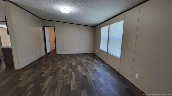 a view of hallway with wooden floor