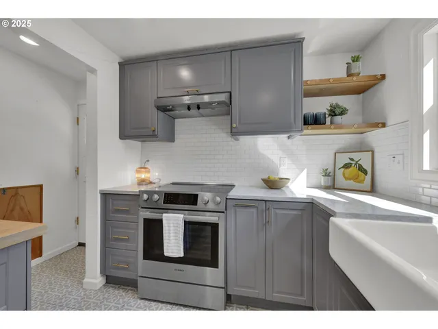 a kitchen with stainless steel appliances granite countertop a sink and wooden cabinets