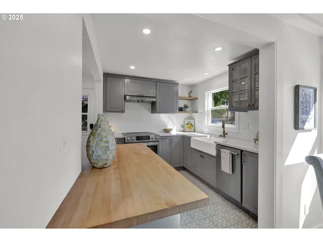 a open kitchen with kitchen island a sink stove and refrigerator
