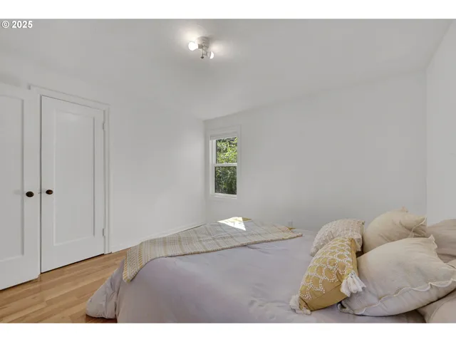 a bedroom with a bed and window