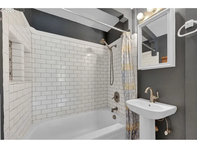 a bathroom with a sink a shower and a mirror