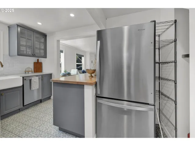 a kitchen with stainless steel appliances a refrigerator and a sink